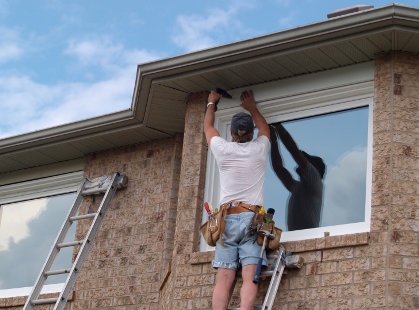 Double glazing installer retrofitting new windows into an older house